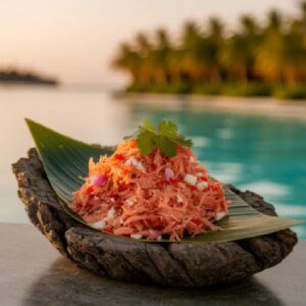 Golden fried Maldivian mas roshi fish fritters on a plate with lime wedges