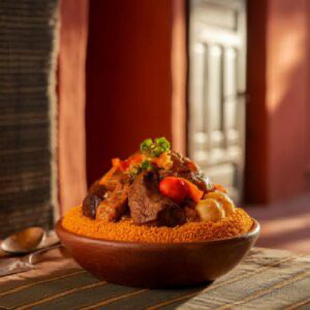 A hearty bowl of Mauritanian chubbagin stew garnished with fresh coriander