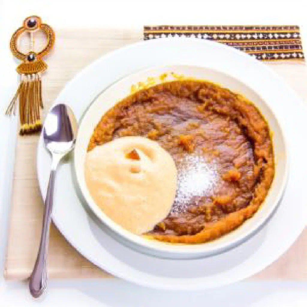 Creamy Eros pudding in a small glass bowl topped with fresh fruit