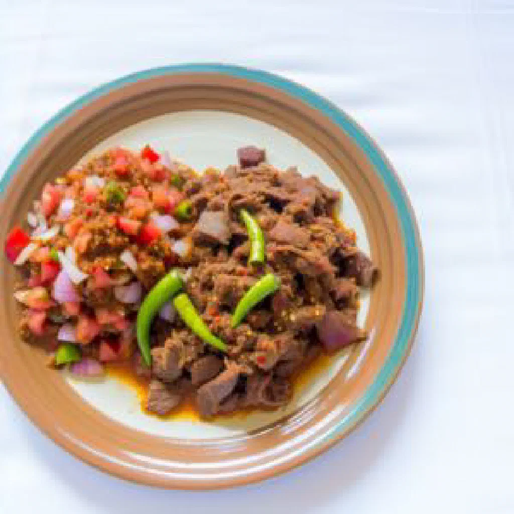 Grilled kapana beef strips with chilli sauce and fresh coriander