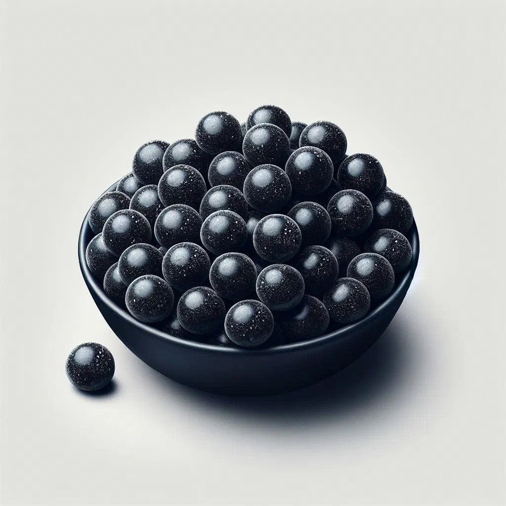 Dark salty liquorice pieces of dubbel zoute drop in a bowl