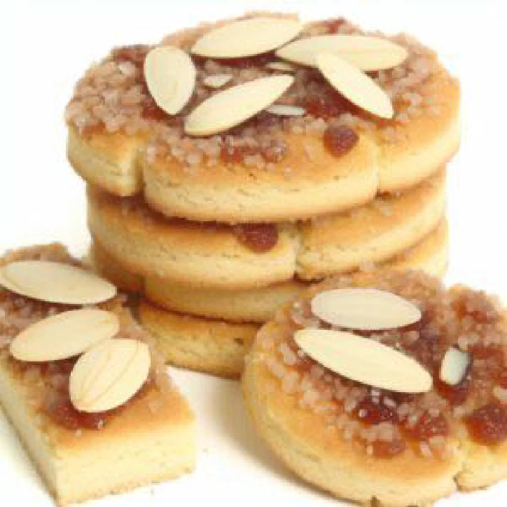 Crisp Jan Hagel biscuits topped with chopped almonds and sugar, cut into squares