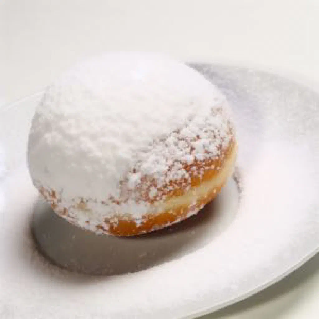 Round Dutch sneeuwballen dusted with icing sugar and filled with cream