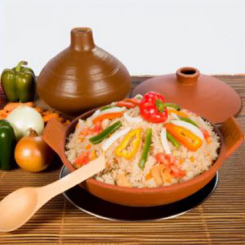 Colourful Djerma rice with chicken, peppers and carrots garnished with fresh herbs