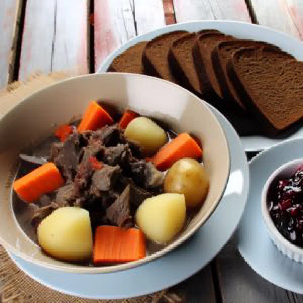 Bowl of Norwegian bidos reindeer stew with potatoes and carrots