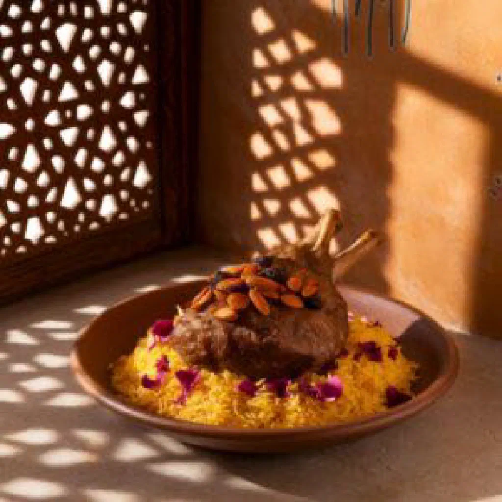 Omani quzi with spiced rice, tender lamb and toasted nuts on a platter
