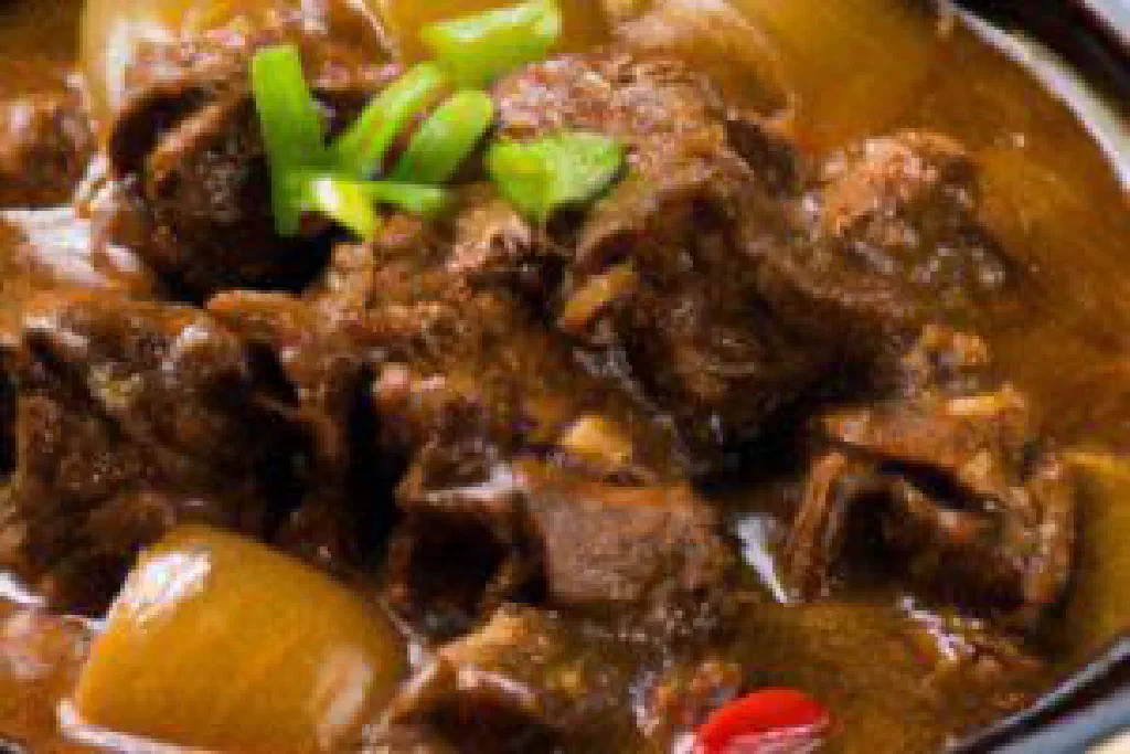 Filipino pork adobo simmered in soy sauce and vinegar, served with rice