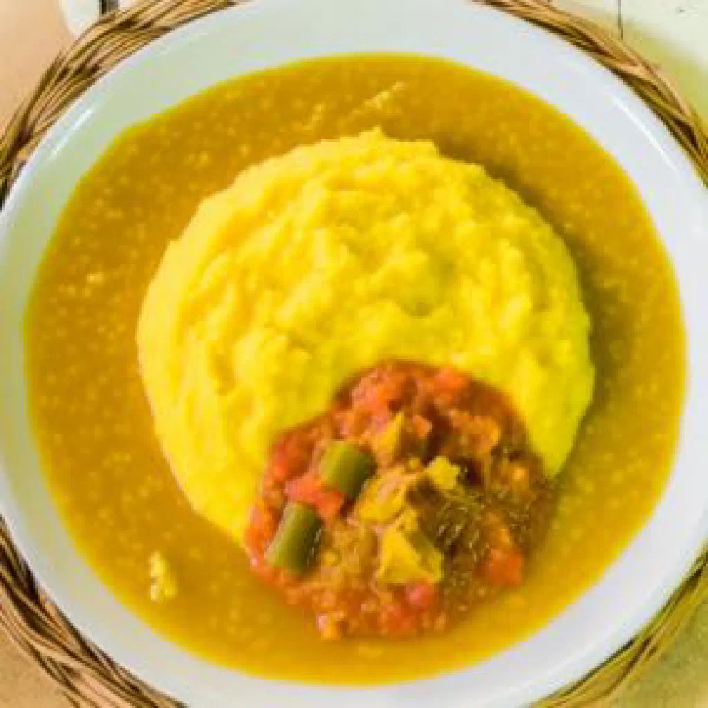 Smooth funge made from cassava flour, shaped into a mound on a plate