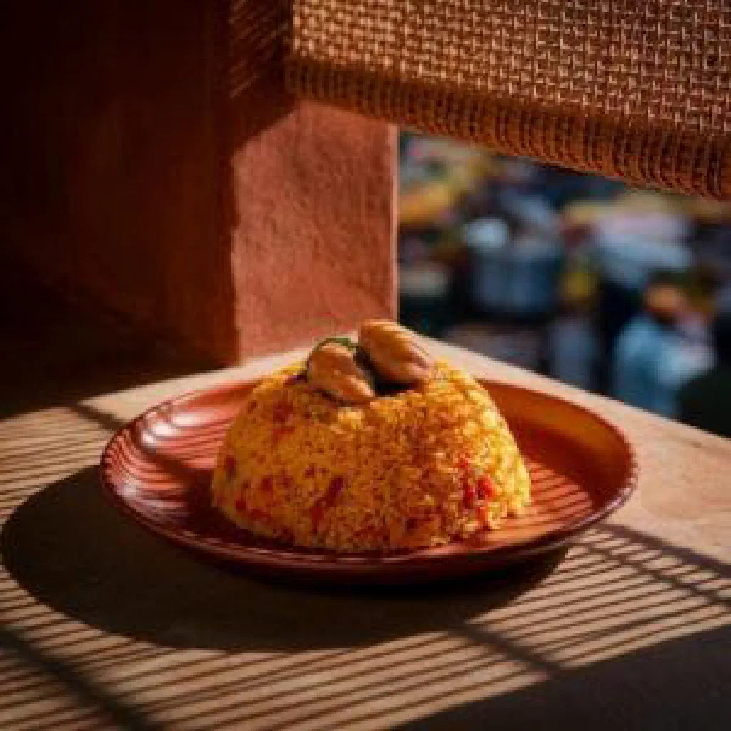 A bowl of Senegalese thiéré with spiced rice, peas and tender meat