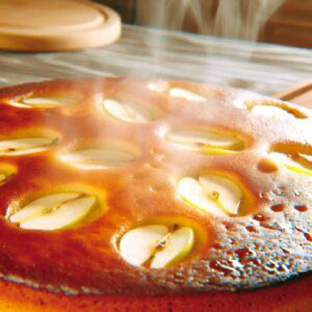 Freshly baked apple cake with a golden crust and cinnamon sugar topping