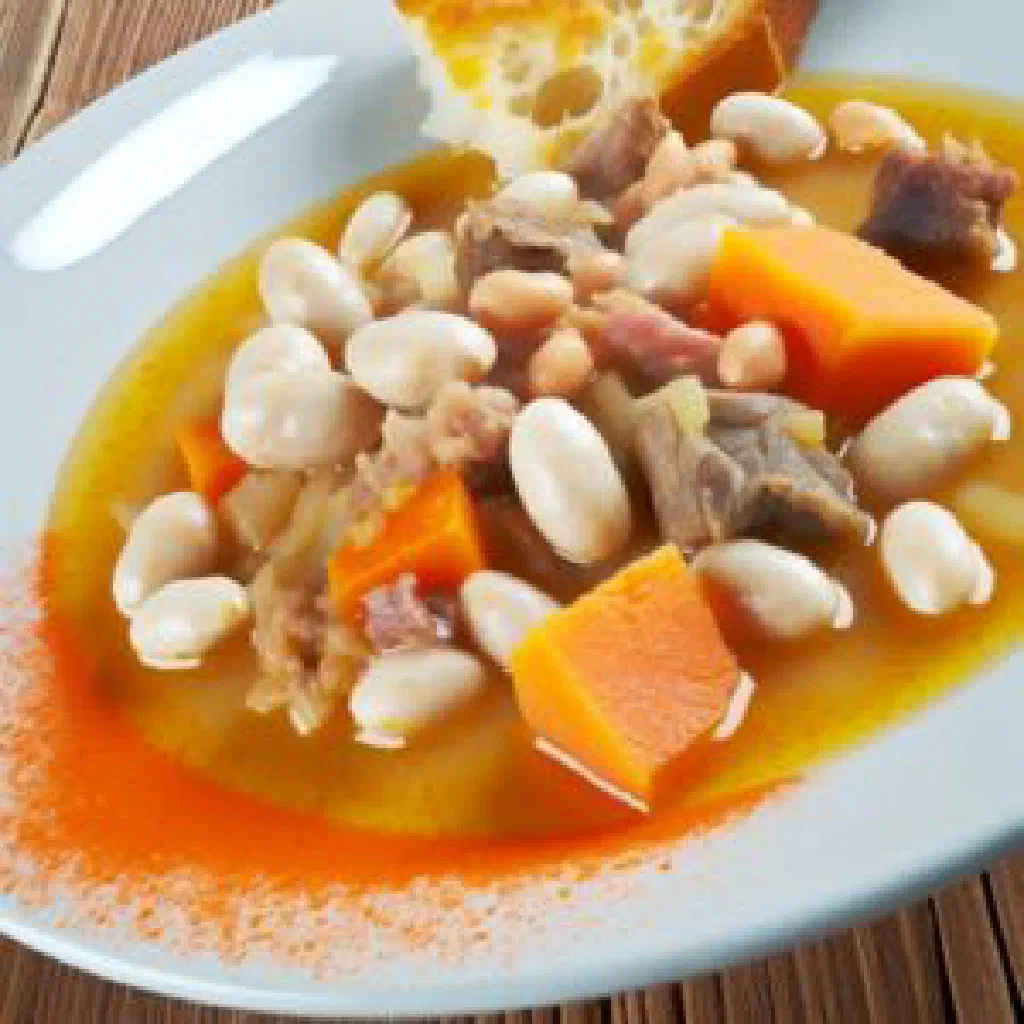 A rustic bowl of Judiones de la Granja butter bean stew with chorizo and bacon