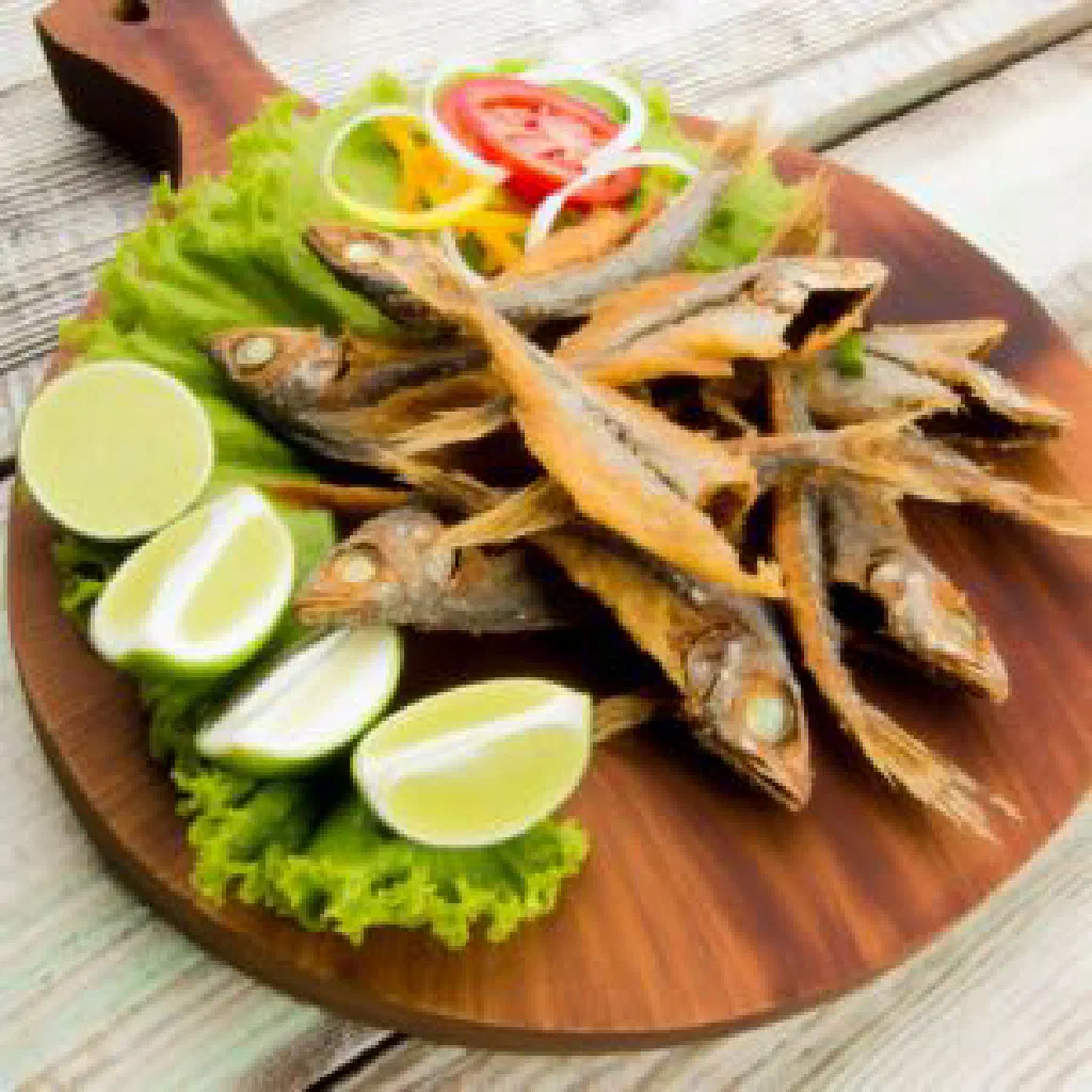 Golden pan-fried flying fish fillets with lime wedges and spicy salsa
