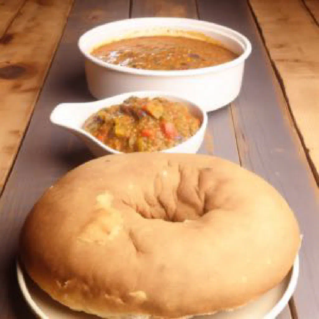 Round golden Sudanese gurassa flatbread stacked on a plate
