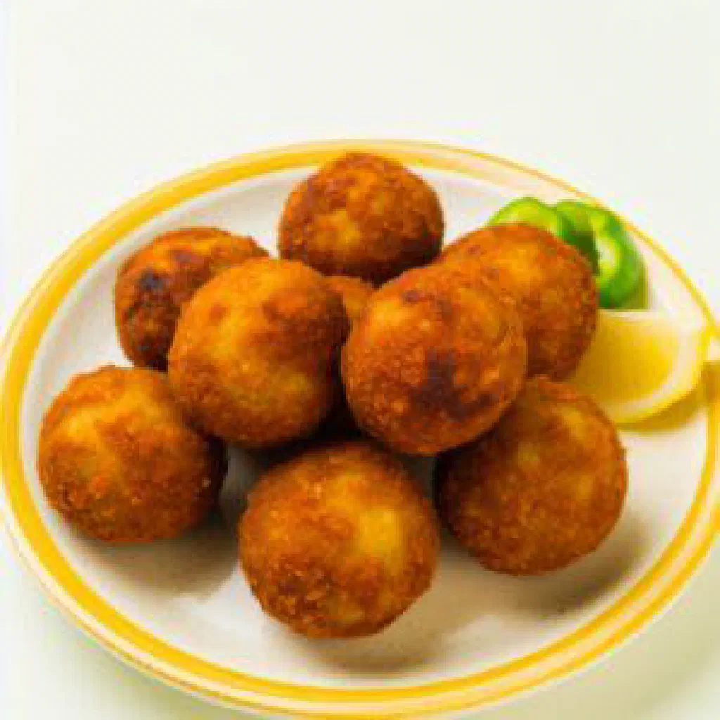 Golden fried tamiya fava bean fritters with fresh herbs and lemon