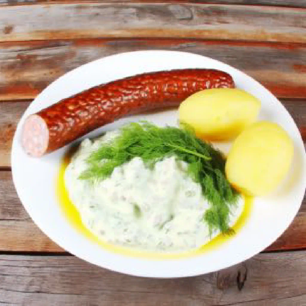 Grilled Swedish isterband sausages served with mustard on a wooden board