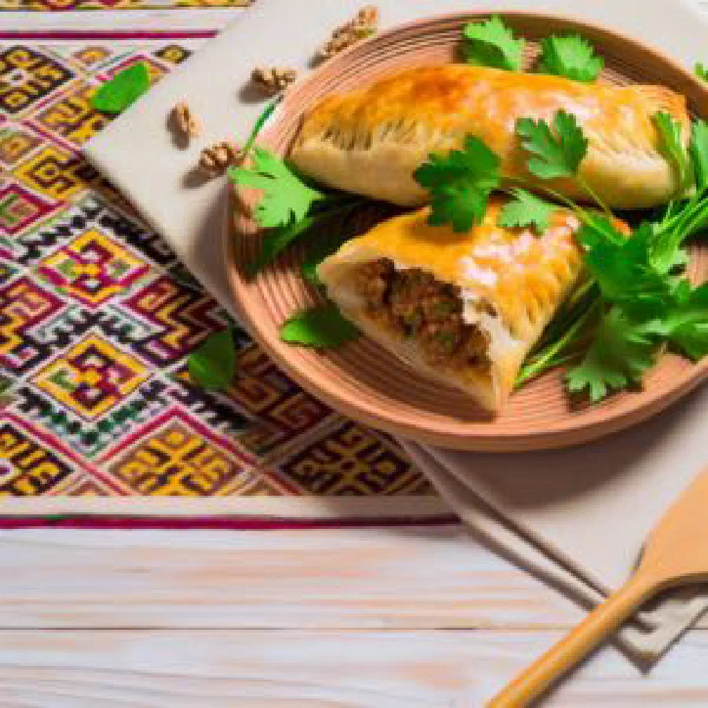Golden fried Tajik gushnan pastries served with yoghurt and fresh herbs