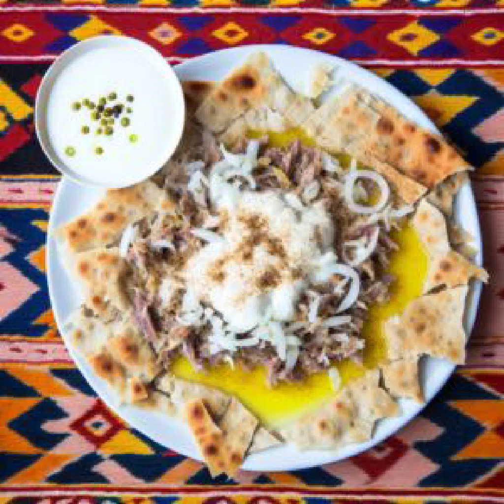 Shakarob salad of tomatoes, cucumber, onion and torn flatbread in a bowl