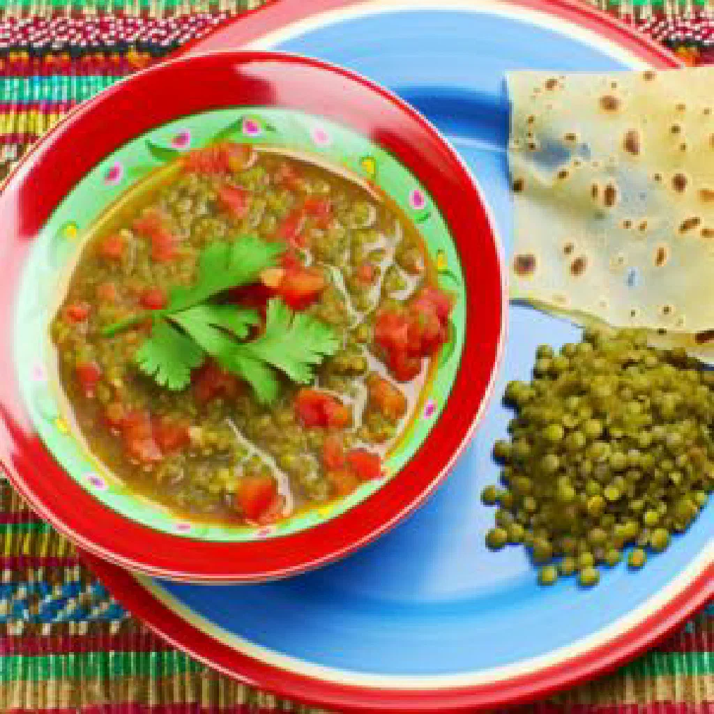Bowl of dengu, spiced green peas garnished with fresh coriander