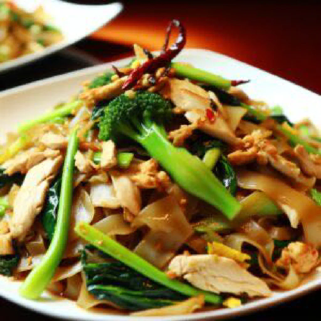 Pad see ew with wide rice noodles, broccoli and seared meat in a glossy soy sauce