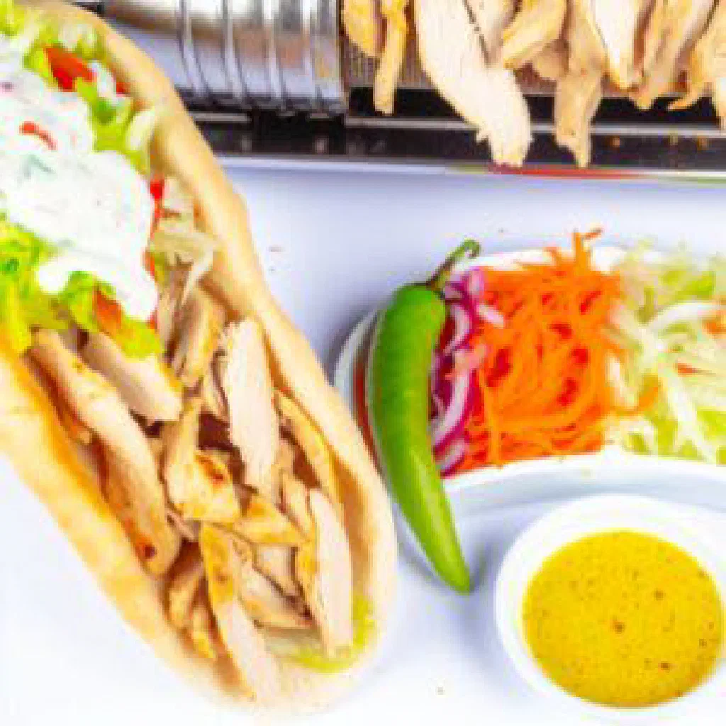 Chicken döner in warm flatbread with fresh salad and yoghurt sauce