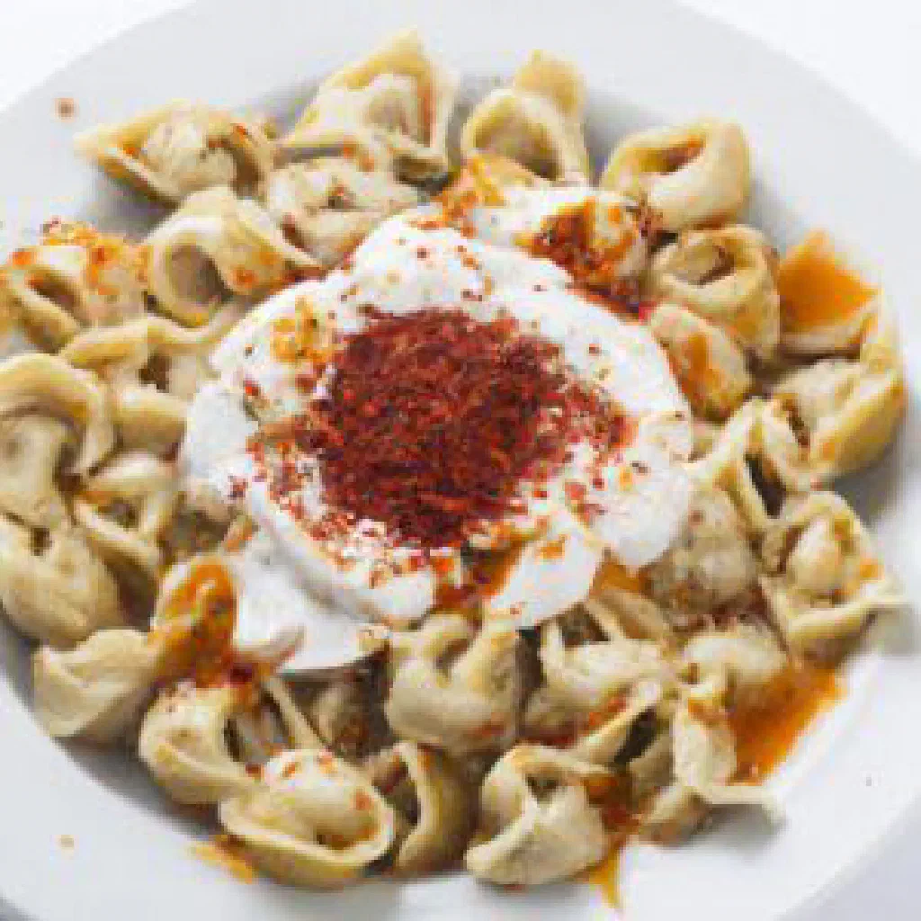 Golden baked Turkish manti pastries filled with spiced minced meat