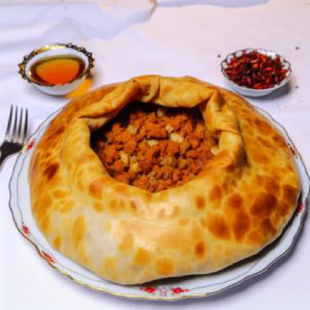A hearty Turkmen ishlekli stew of meat and vegetables garnished with fresh herbs
