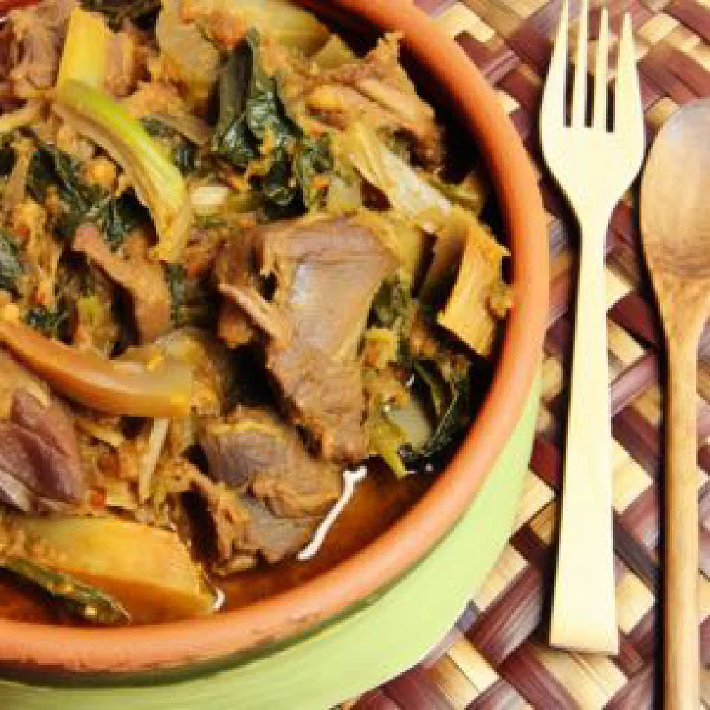 Bowl of Gobe with green bananas in a creamy peanut sauce
