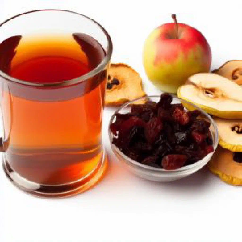 A glass of Ukrainian uzvar with pieces of dried fruit