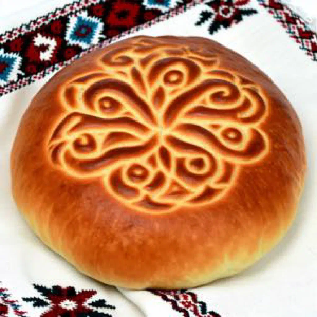 Round Uzbek obi non flatbread with a golden, patterned crust