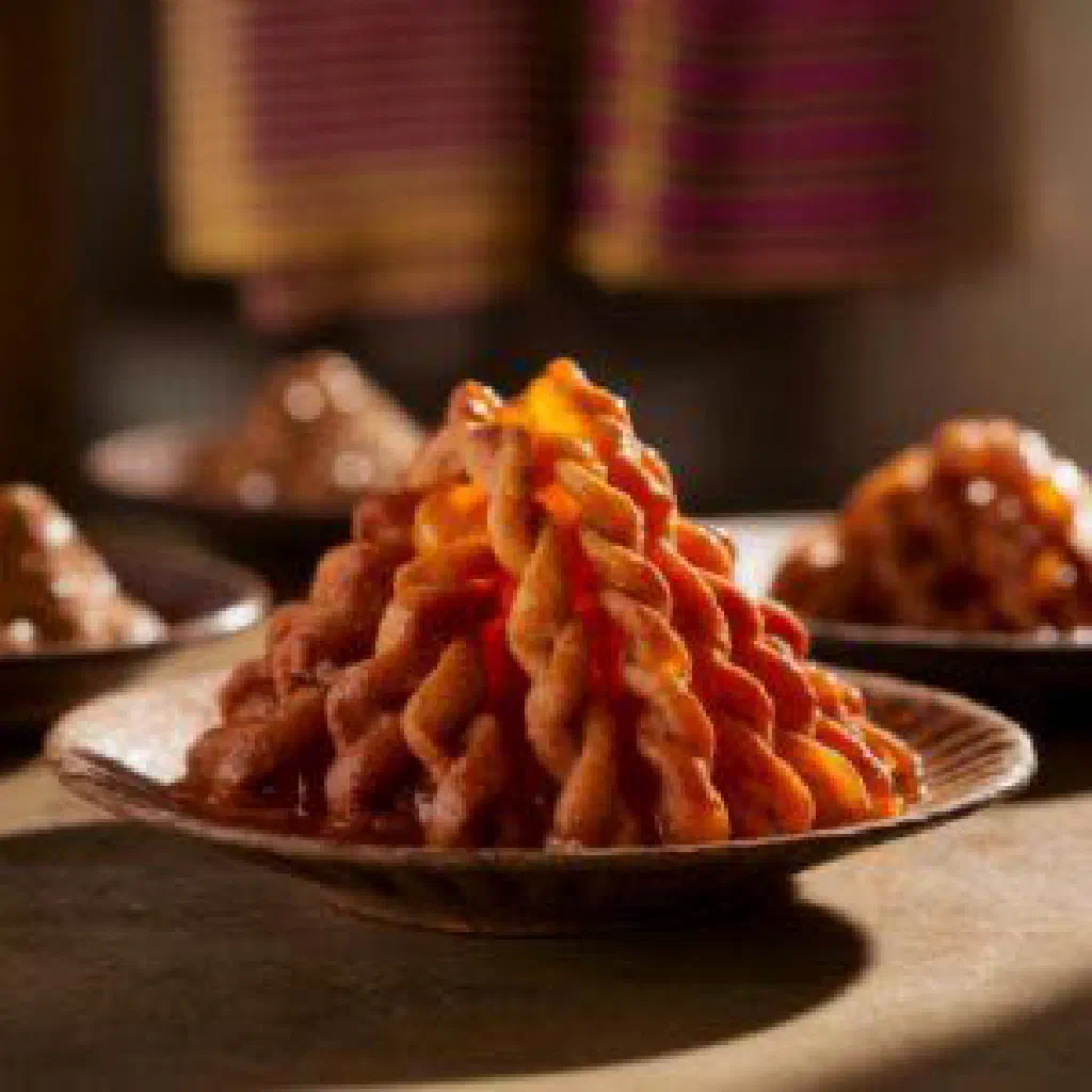Golden fried zalabiya drizzled with honey syrup